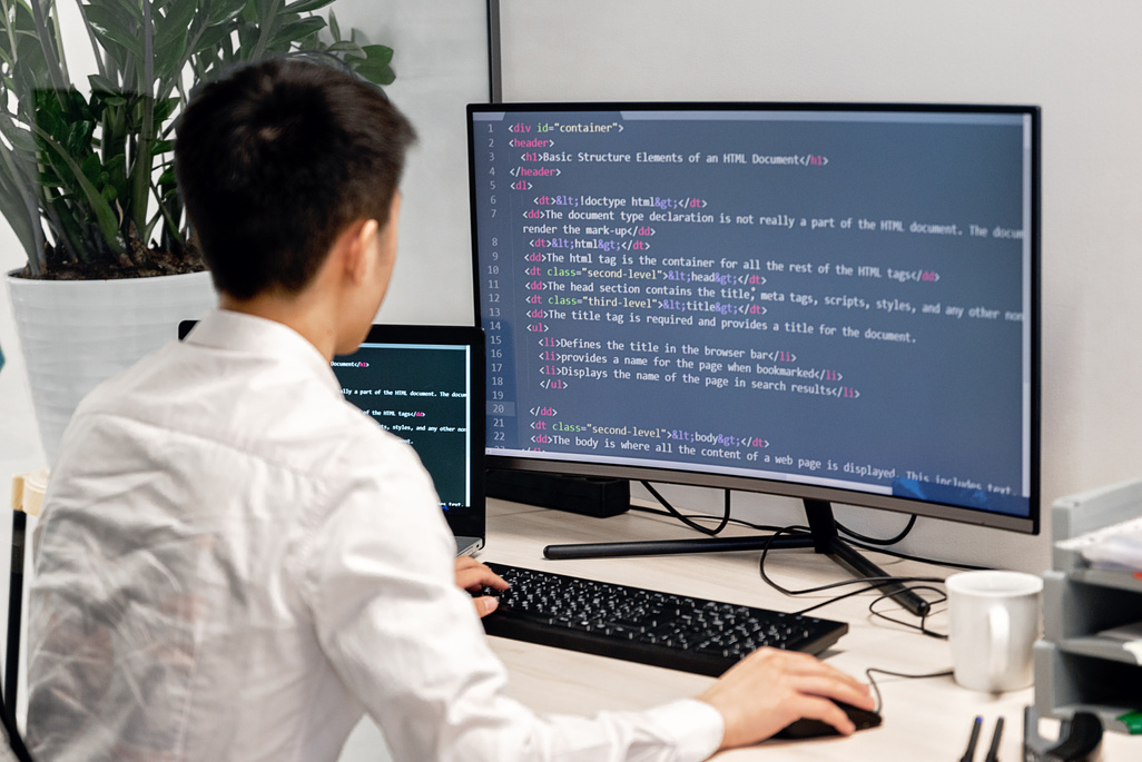 Back View Shot of a Man Working on His Computer