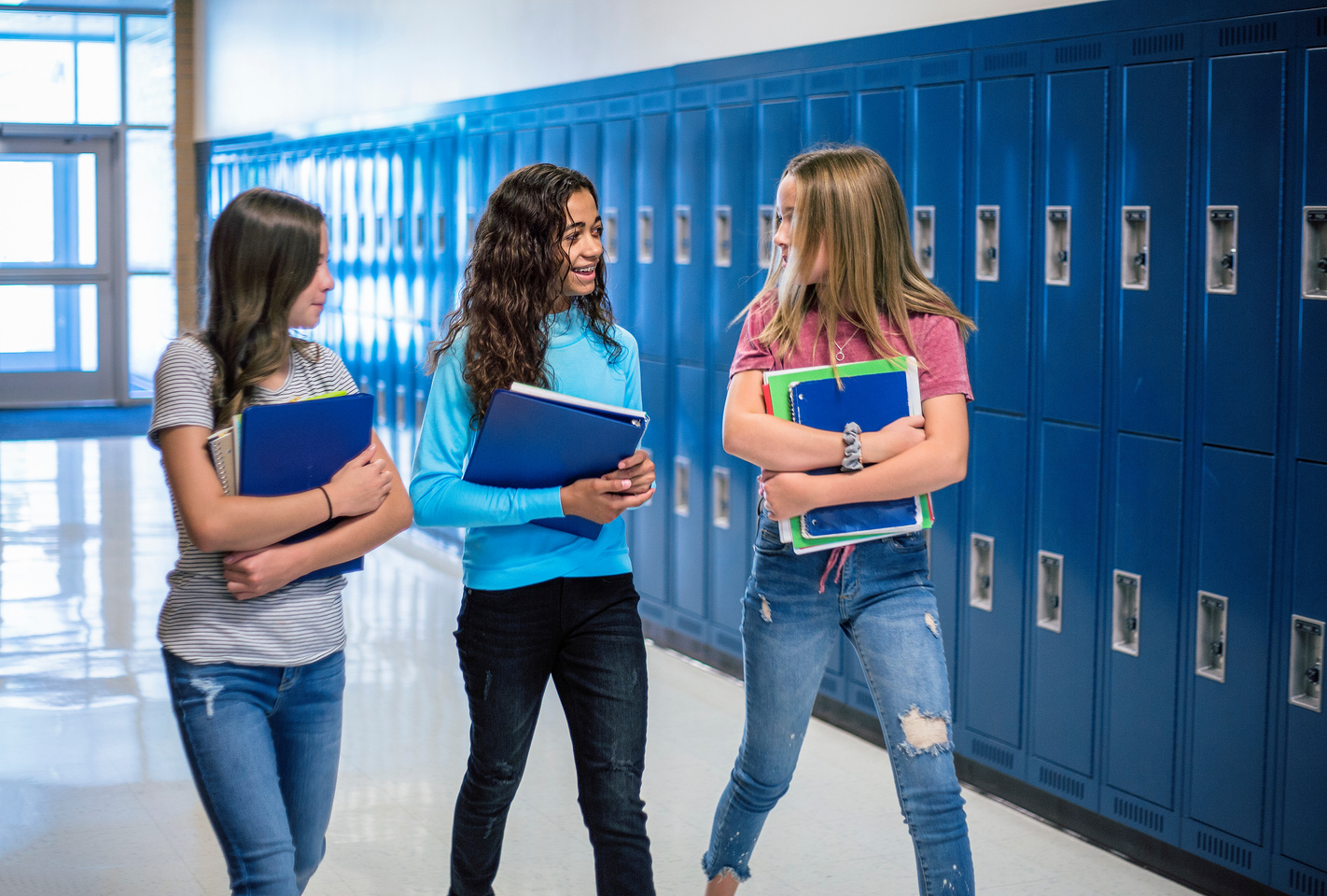 Junior High school Students talking and walking in the hallway in a junior high school