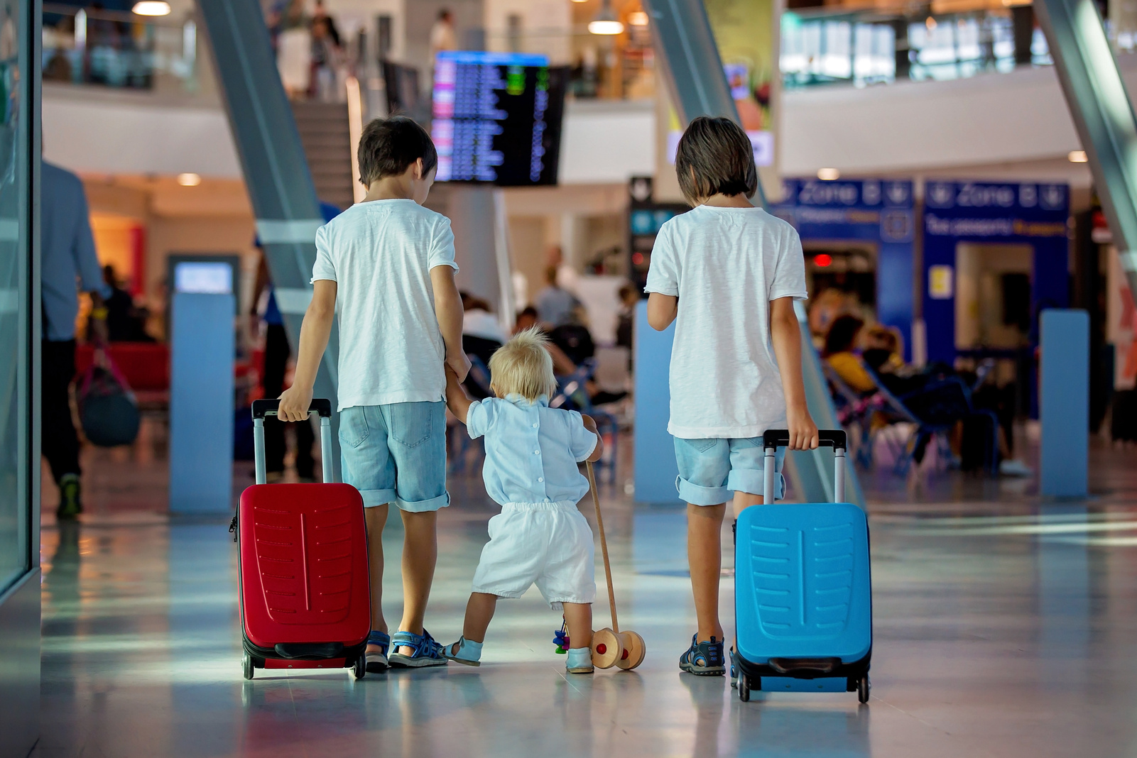 Children, traveling together, waiting at the airport for boarding