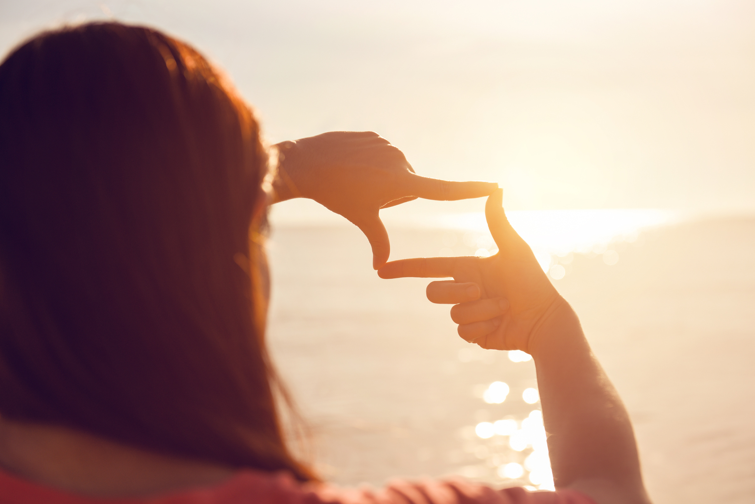 Woman hands making frame gesture with sunrise, Imagine Future