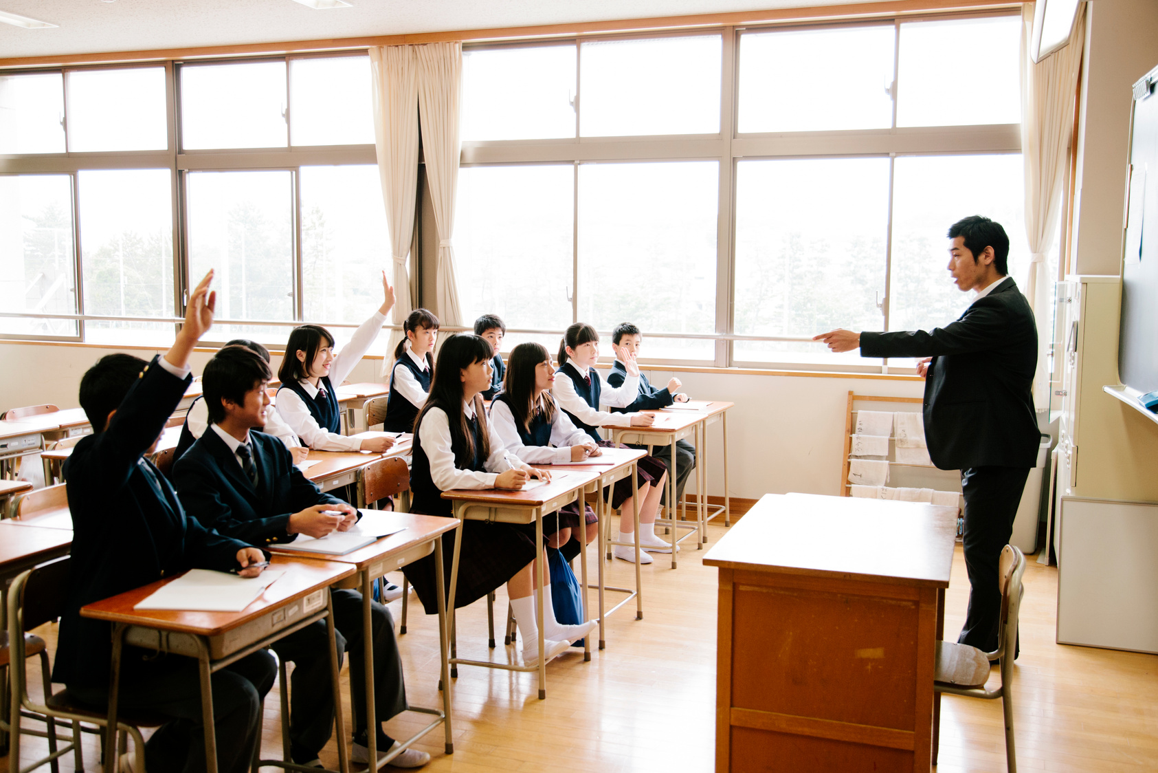 High school children at school, teacher teaching his class, Japan